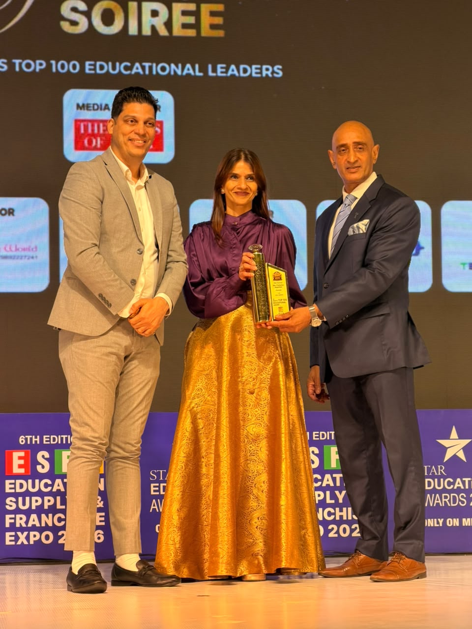Fatema Agarkar receiving the Top 100 Educational Leaders award on stage at NESCO Mumbai